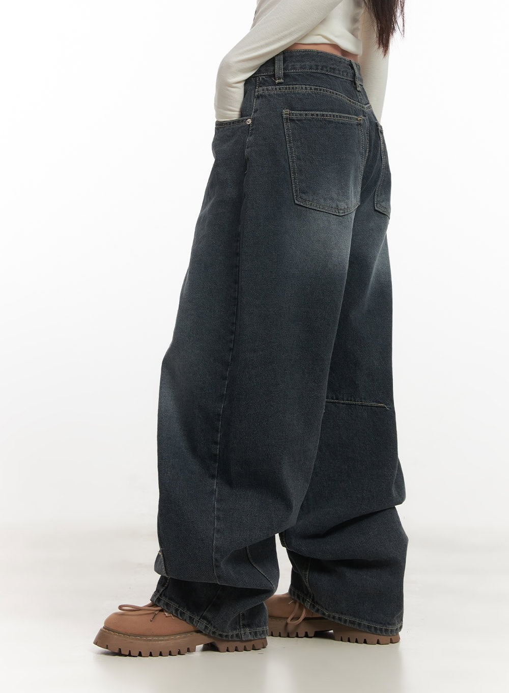 Giselle Stitched Balloon-Fit Jeans CF526 in dark blue, side close-up on model showing back pocket detail, panel seam at knee, and washed fading on wide-fit cotton denim leg.