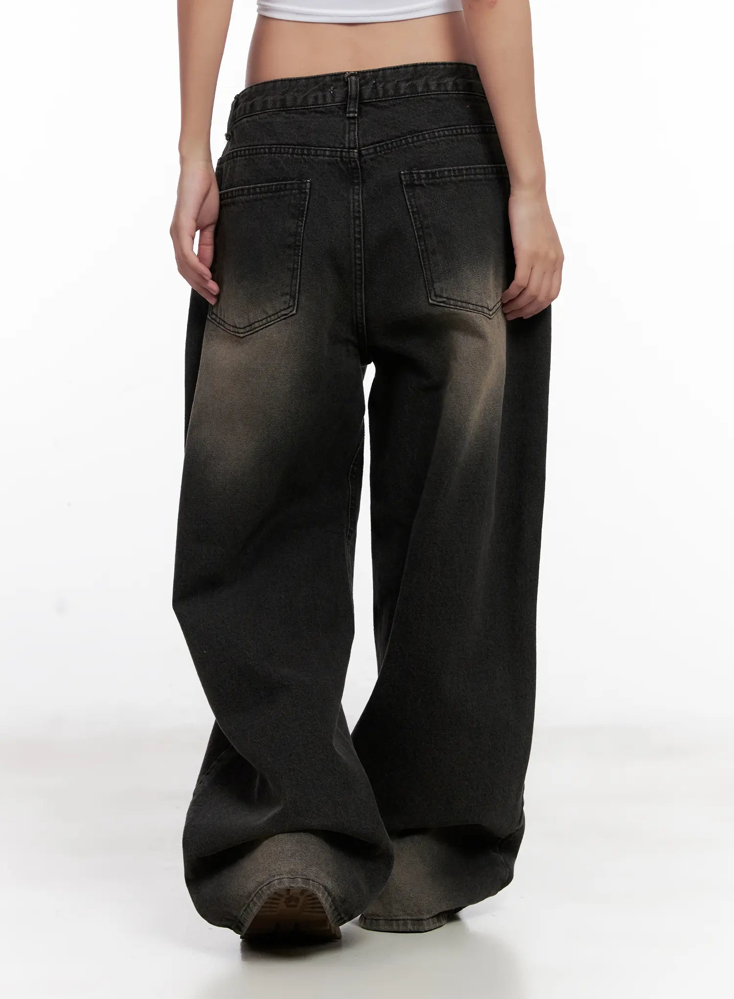 Ari Washed Wide-Leg Denim Jeans CL521 in Black, back close-up on model, dual back pockets with stitching detail, heavy washed fade and extra-wide leg pooling at hem.