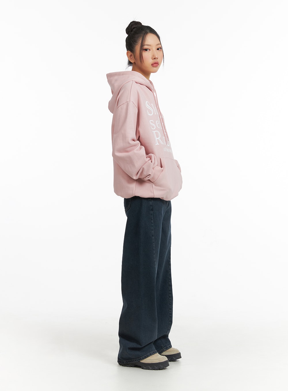 Washed Wide Leg Jeans CJ429 in dark blue, side profile full-length shot on model, wide leg cotton denim with clean inseam, styled with oversized pink hoodie.
