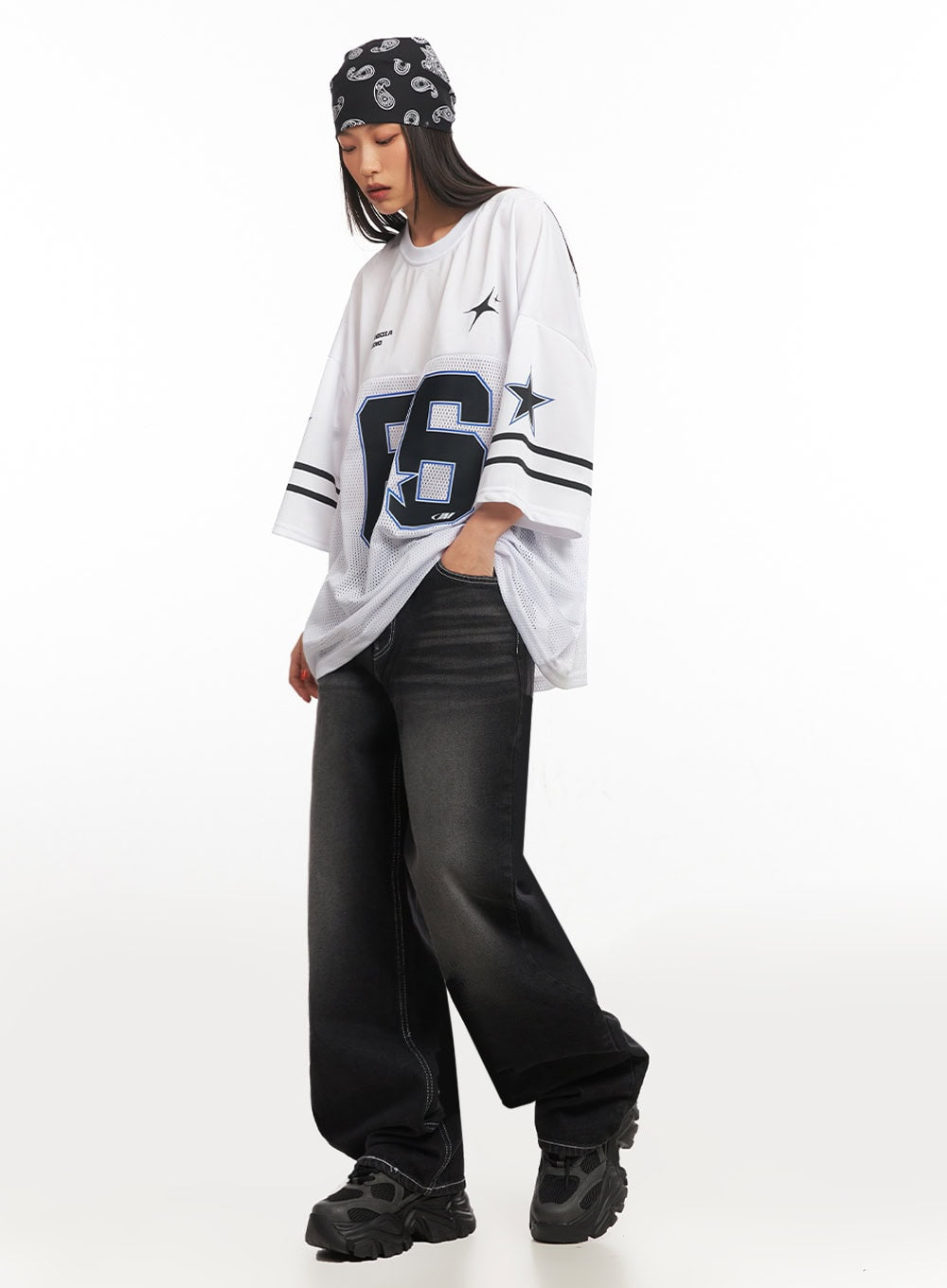 Alexis Stitched Wide-Leg Jeans IA504 in washed black, three-quarter front angle on model looking down, wide-fit washed denim with contrast stitching, paired with oversized street-style jersey.
