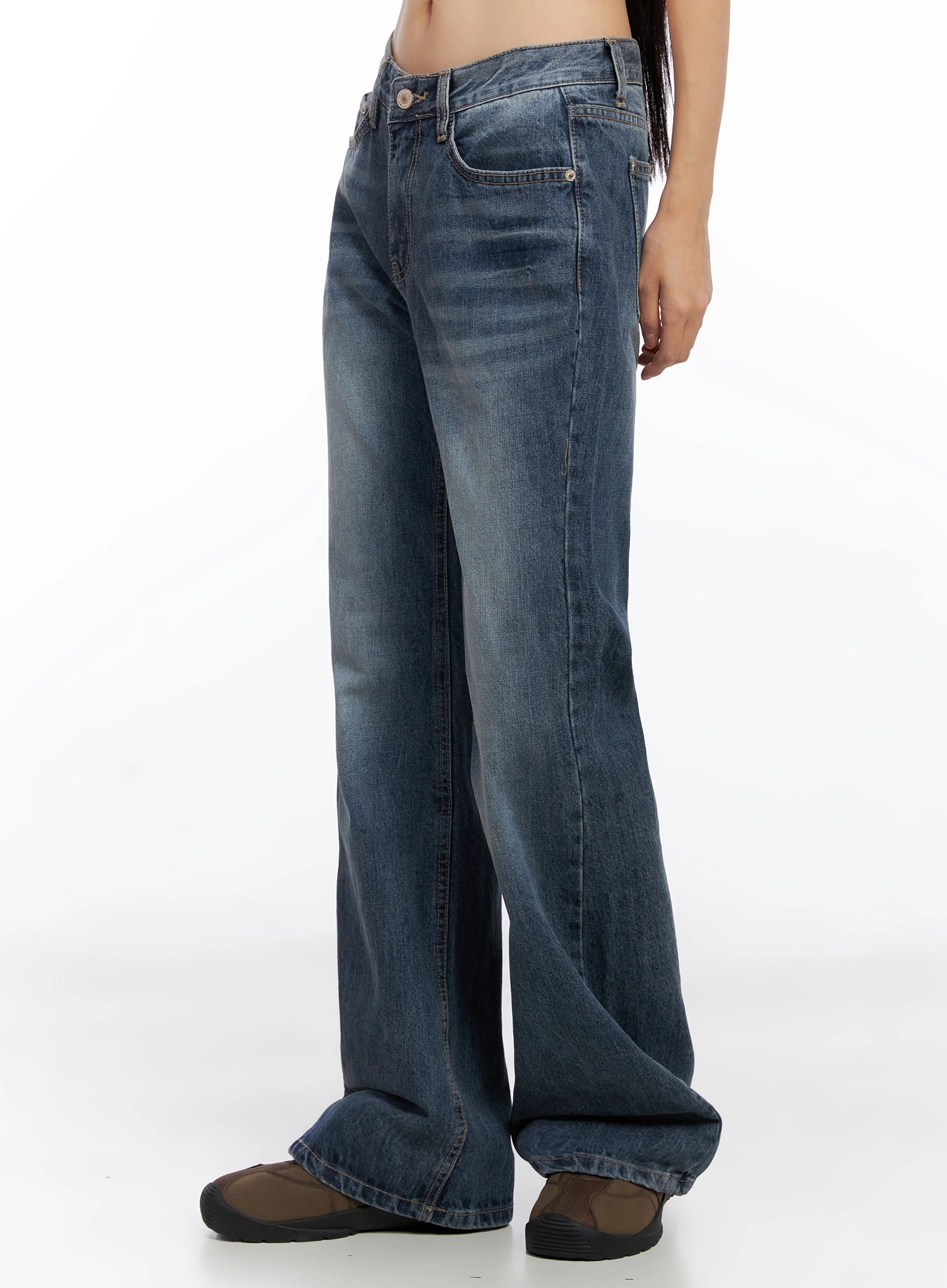 Myra Washed Bootcut Jeans IO516 in dark blue, side-angle view on model, full-length silhouette highlighting bootcut flare from knee to hem, washed denim with contrast stitching.