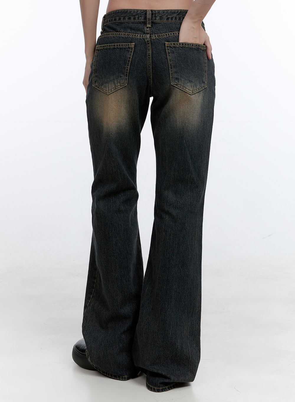 Kira Stitched Detail Bootcut Jeans CG414 in dark blue, back view on model, washed denim showing amber fading on back pockets and thighs, subtle bootcut hem flare, topstitching detail throughout.