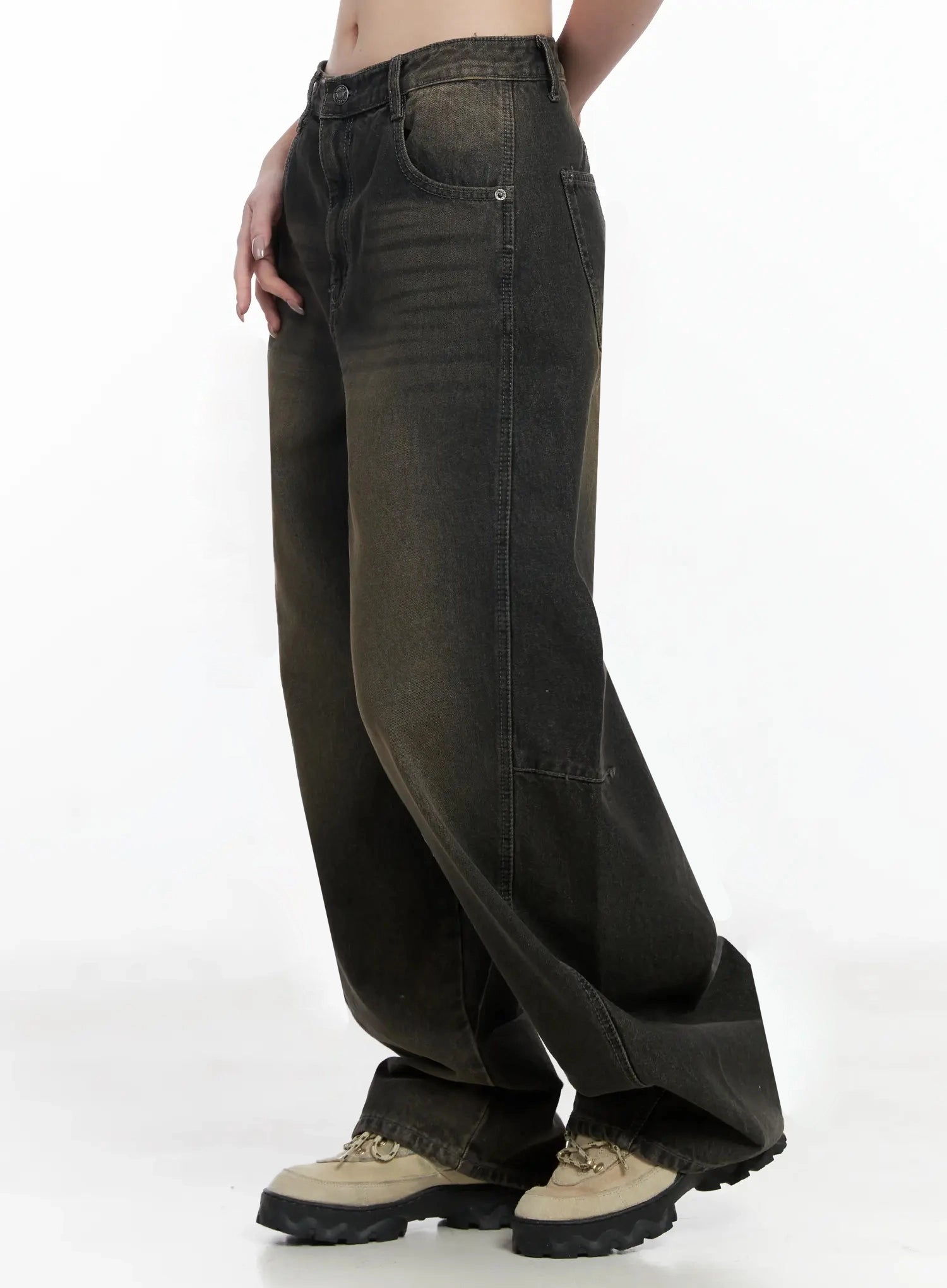 Tracey Vintage Black Washed Wide Leg Jeans IJ528 in black, side mid-shot headless on model, wide-leg silhouette with visible seam panel, brown-to-black vintage wash, long hem over chunky boots.