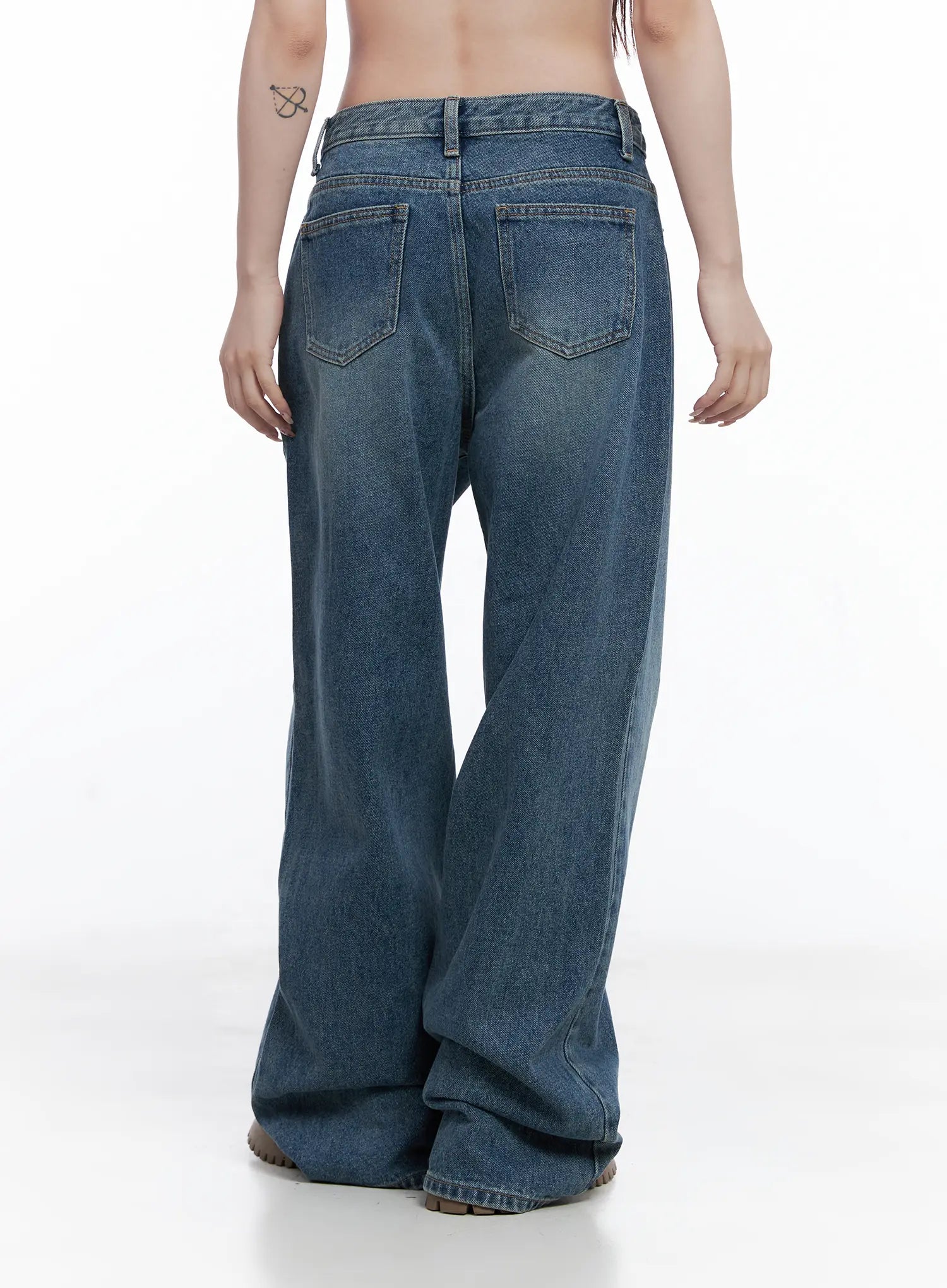 Amalia Wide Leg Vintage Washed Jeans CG529 in blue, back view on model showing twin back pockets with stitching, wide-leg hem pooling at floor, vintage wash fade across seat.