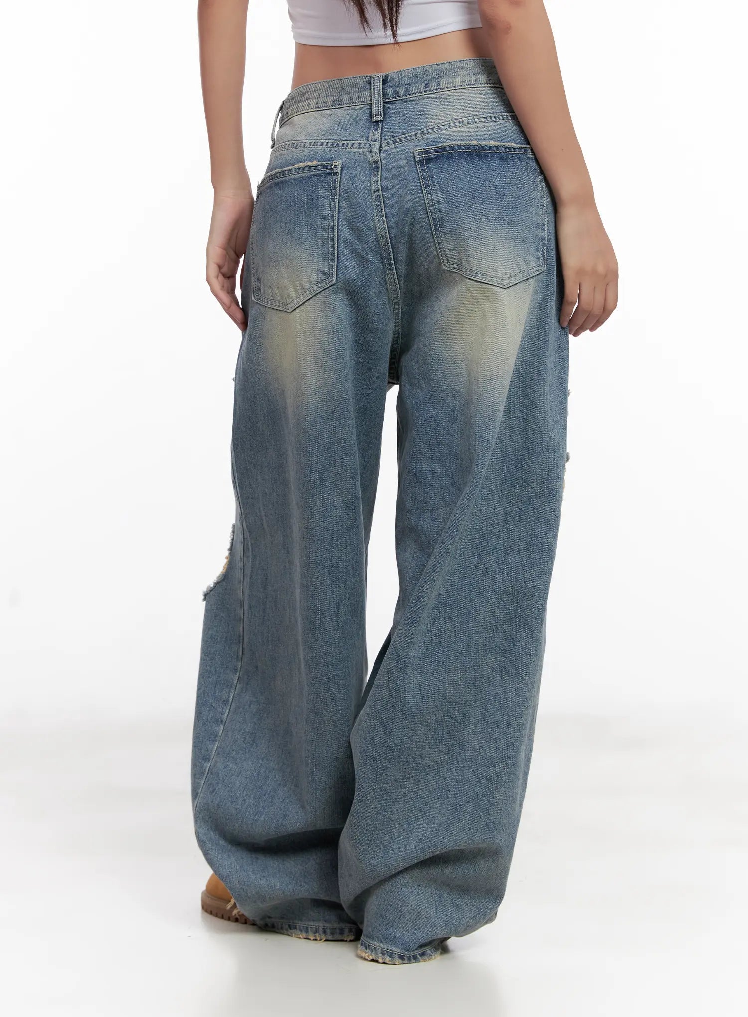 Manon Washed Distressed Wide Jeans CL518 in blue, back view on model, washed fading on seat and back thighs, dual back pockets, wide-leg silhouette pooling at hem.
