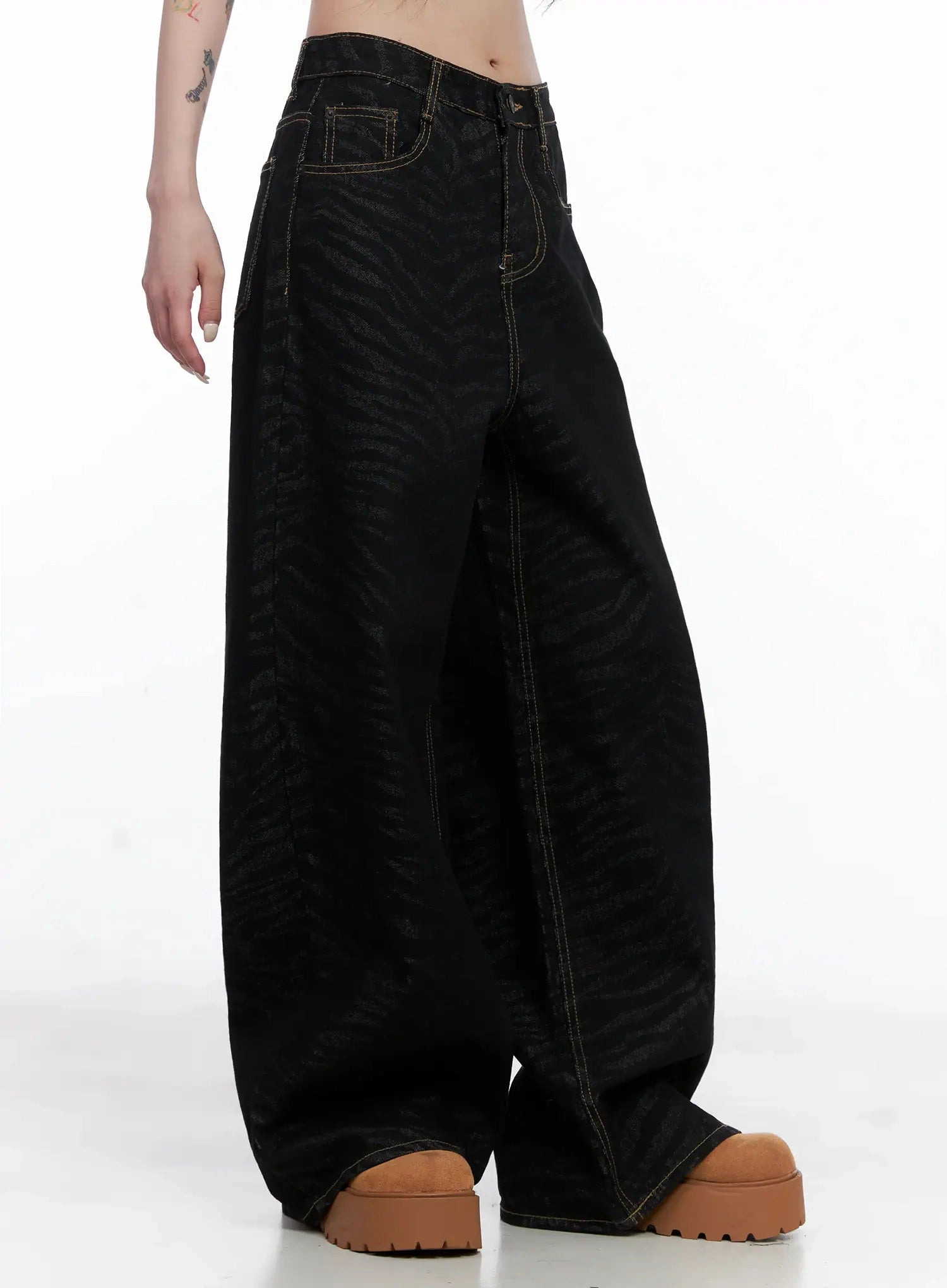 Freyja Animal Print Wide Leg Jeans IS508 in black, side close-up on model, wide-leg zebra-print denim showing exaggerated leg volume and gold contrast topstitching.
