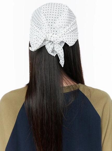 Polka Dot Head Scarf CU519 in White, back view on model showing tied knot detail at nape, white fabric with all-over black polka dot pattern, worn with raglan tee.