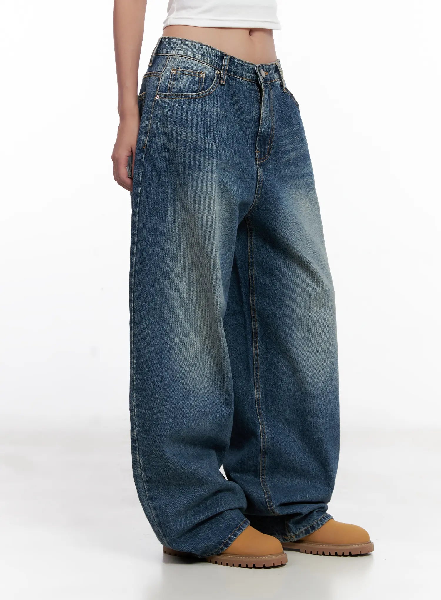 Miji Wide-Leg Washed Denim Jeans CL521 in dark blue, side view waist-to-hem product shot on model, wide balloon leg with subtle fading, front pockets visible, worn with white crop top and tan boots.