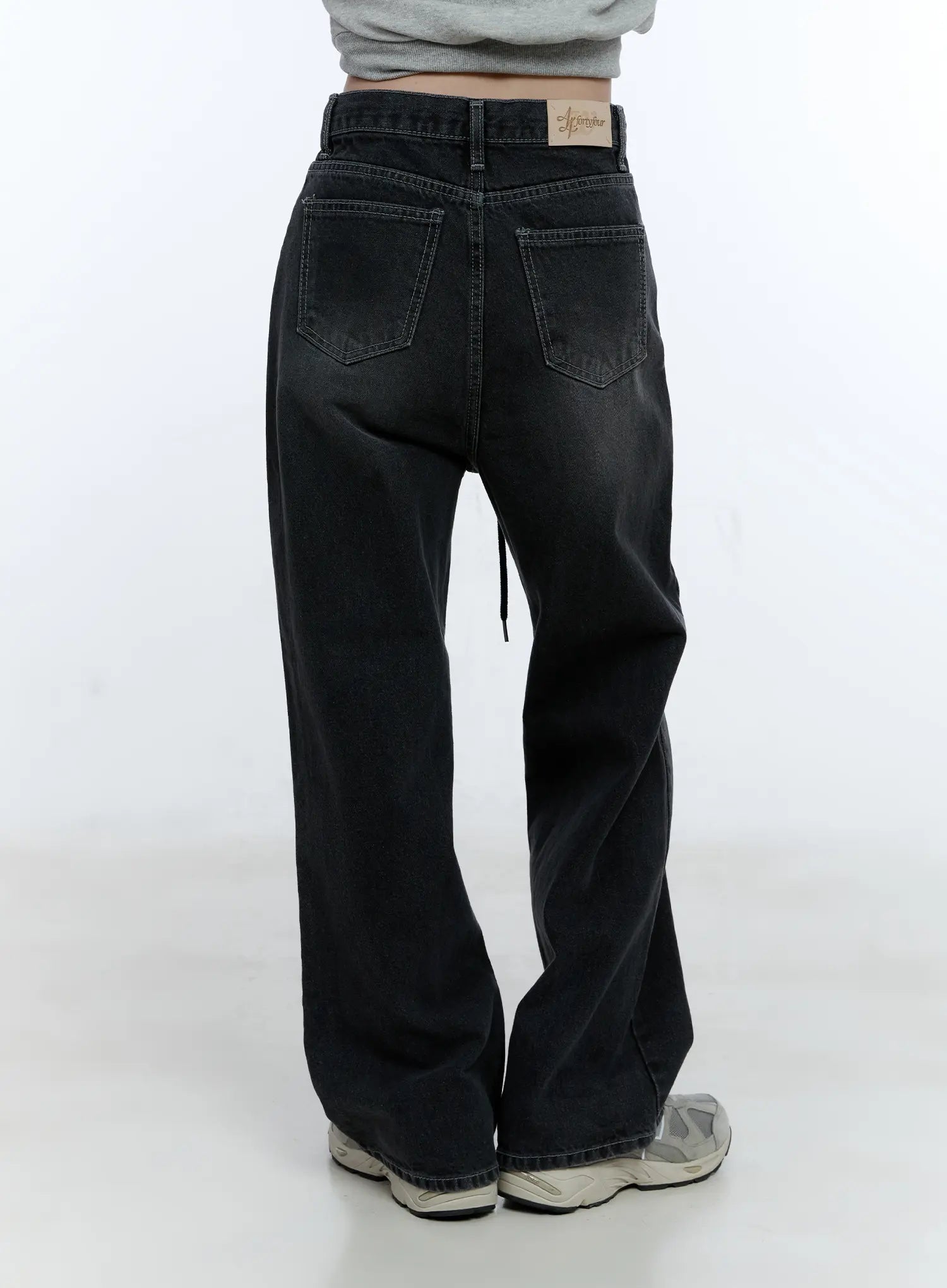 Lucinda High-Rise Wide Leg Jeans CG512 in black, close-up back view on model, washed denim with dual back pockets and brand label on waistband, drawstring visible at side, wide leg hem.