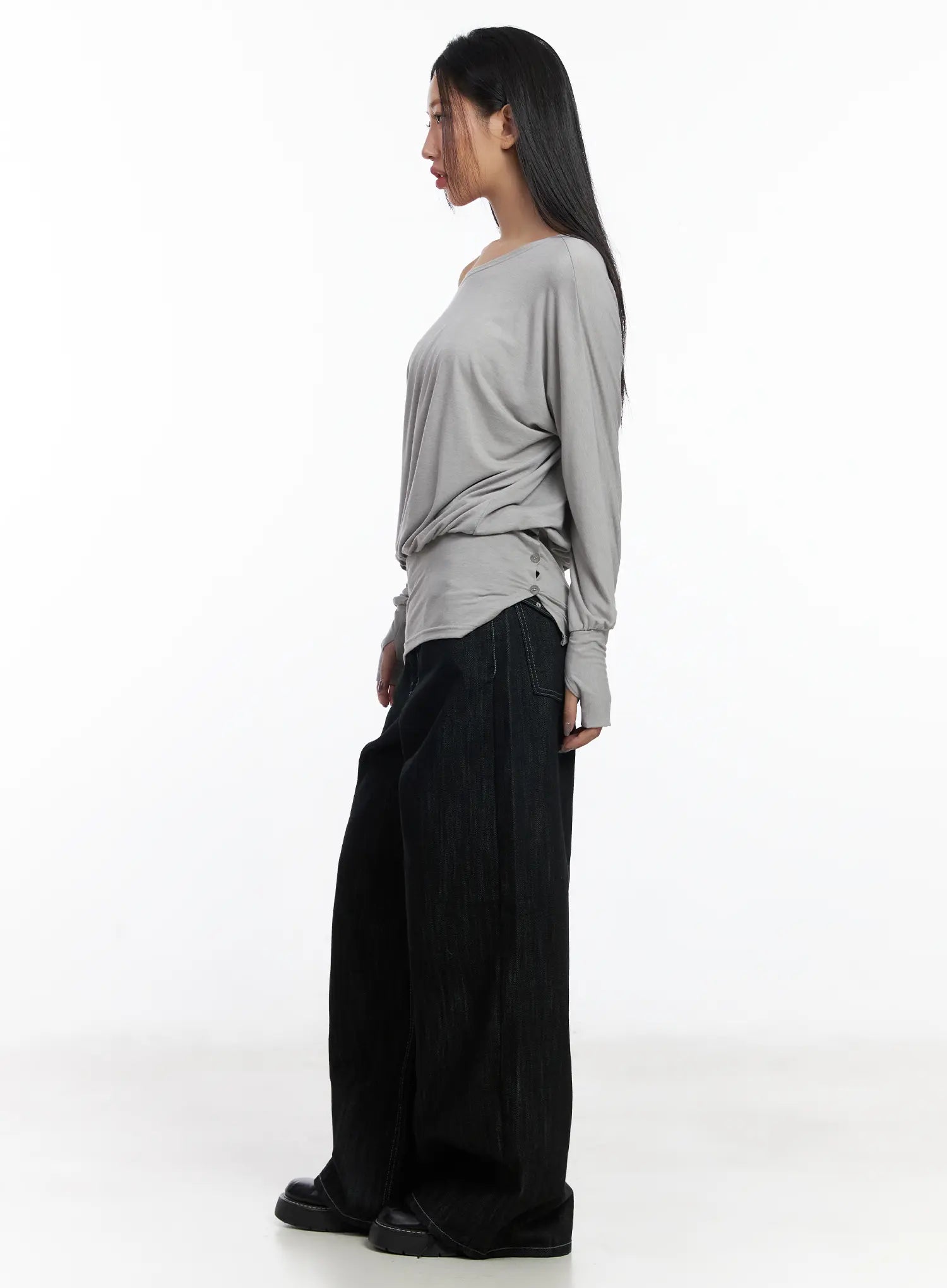 Violet Studded Baggy Jeans CJ530 in black, side full-body view on model styled with grey long-sleeve draped top, ultra-wide leg denim falling to the floor, black loafers, street style.