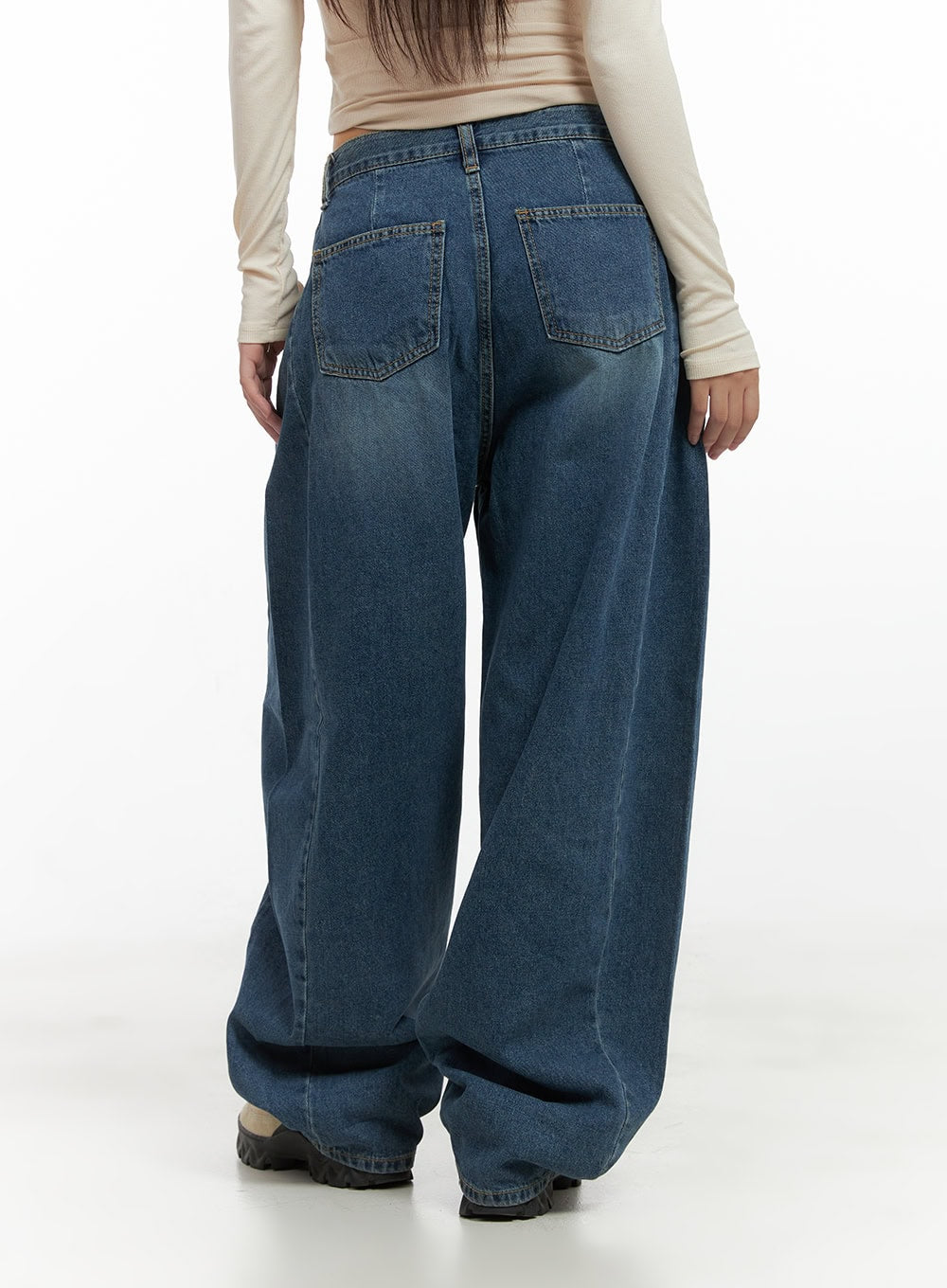Lacey Washed Denim Baggy Jeans CO404 in blue, back close-up on model, dual patch pockets with contrast stitching, washed gradient denim, wide-leg hem gathered at ankle.