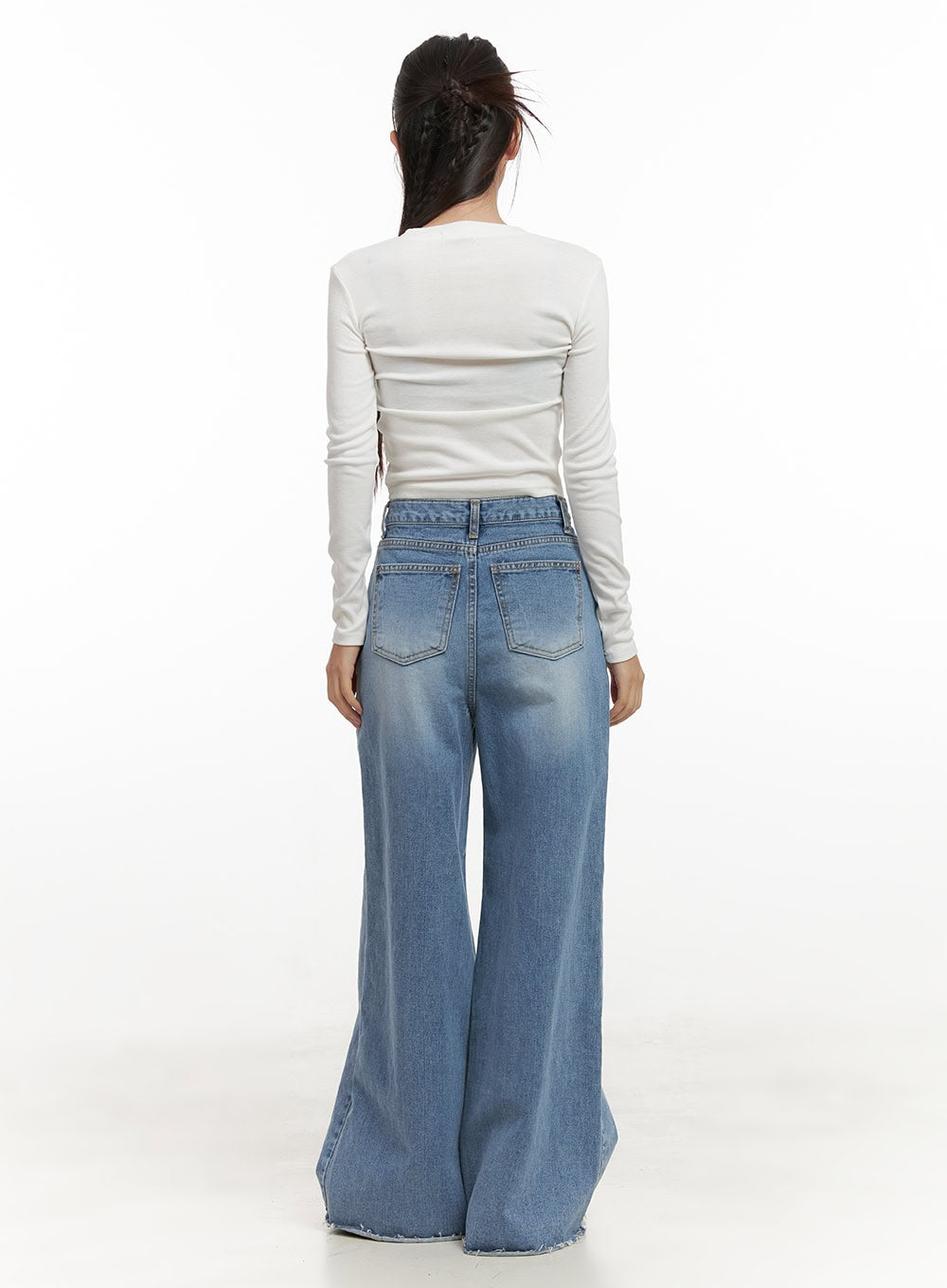 Melody Chic Flare Wide Leg Jeans CN428 in light blue, full-body back view on model, wide-fit washed denim with flared leg and frayed hem, paired with white long-sleeve top and black sneakers.