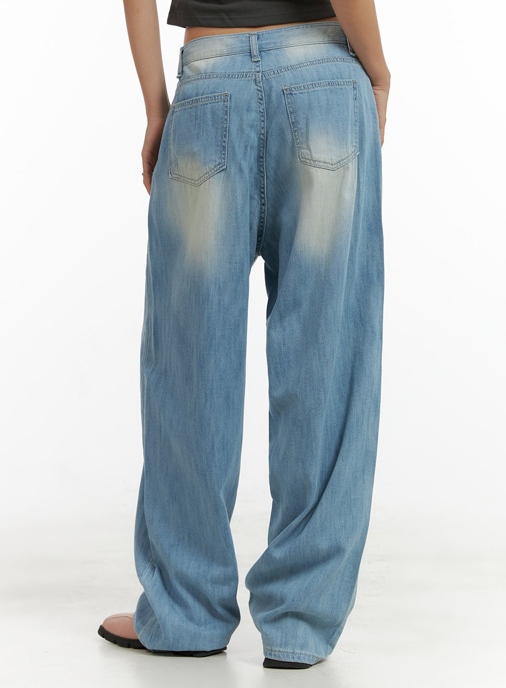 Washed Comfort Baggy Jeans CU414 in light blue, back close-up from waist to hem on model, showing dual back pockets, center seam, and sun-faded washed denim texture.