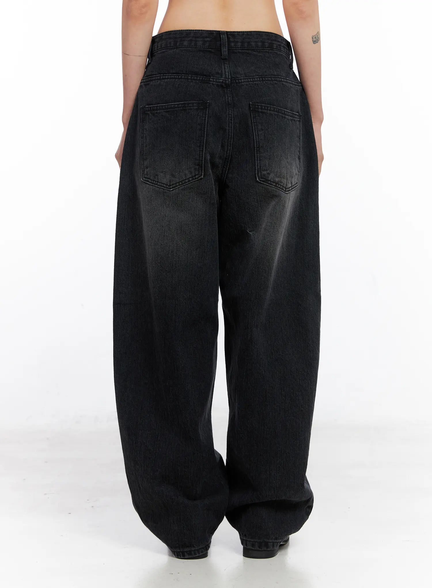 Ivey Washed Baggy Jeans CC1809 in black, back view on model, showing two back pockets, wide balloon leg silhouette, washed cotton denim with faded finish.