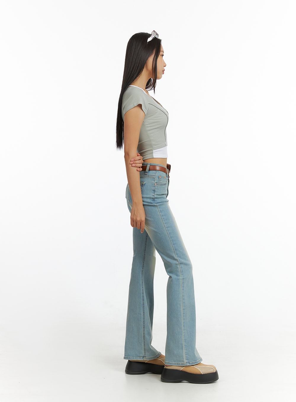 Light Washed Slim Fit Bootcut Jeans IL409 in light blue, full side profile on model standing, showing slim silhouette, bootcut flare at ankle, and front pocket detail with belt.