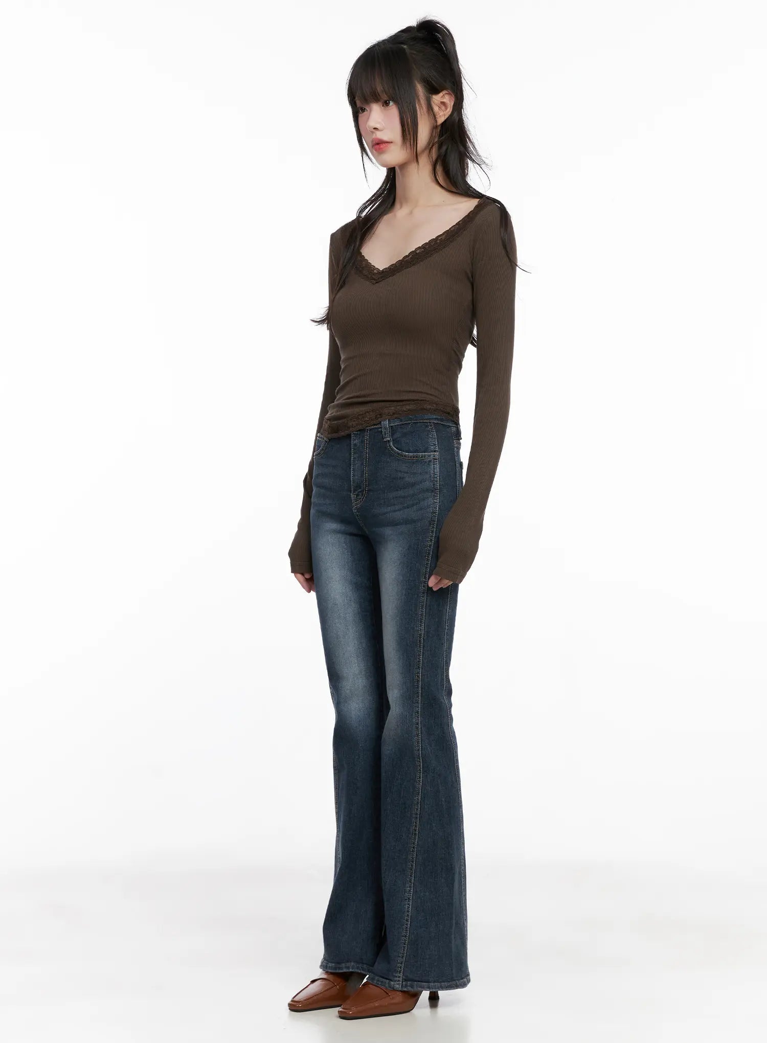 Giana High Waist Hip Pad Flare Jeans CG519 in blue, three-quarter front on model, paired with brown lace-trim ribbed top, elongating high-waist flare silhouette.