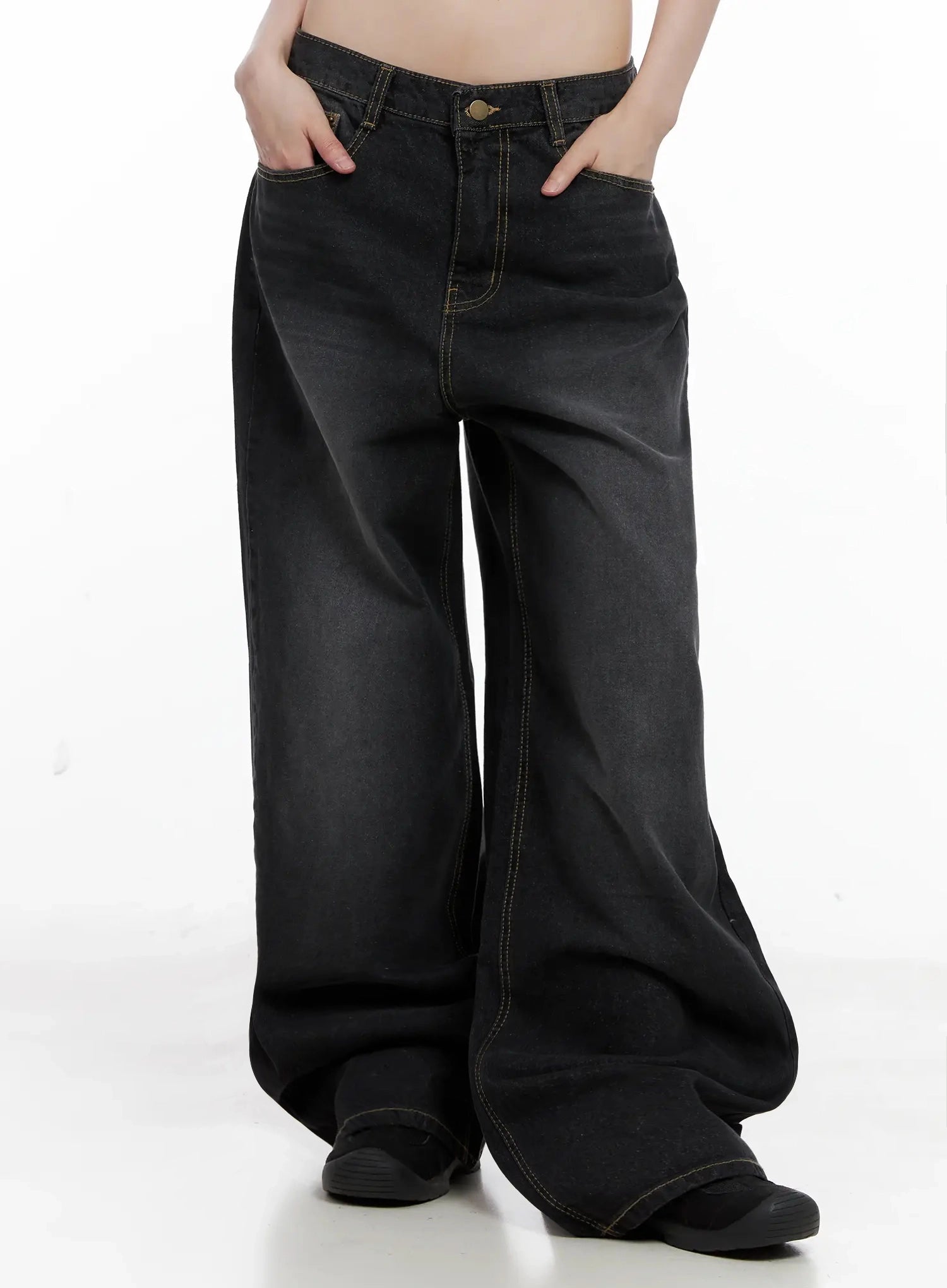 IU Vintage Black Baggy Jeans IL528 in black, front lower-half shot on model, hands in pockets, washed cotton wide-leg with contrast stitching, oversized pooling hem detail.