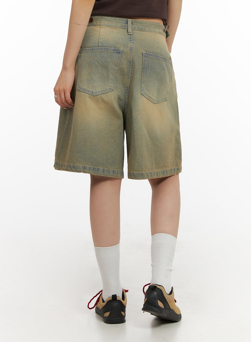Vintage Washed Baggy Jorts IY410 in light blue, back view close-up on model, showing dual patch pockets, sun-faded denim with warm golden tones, and relaxed wide-leg cut.