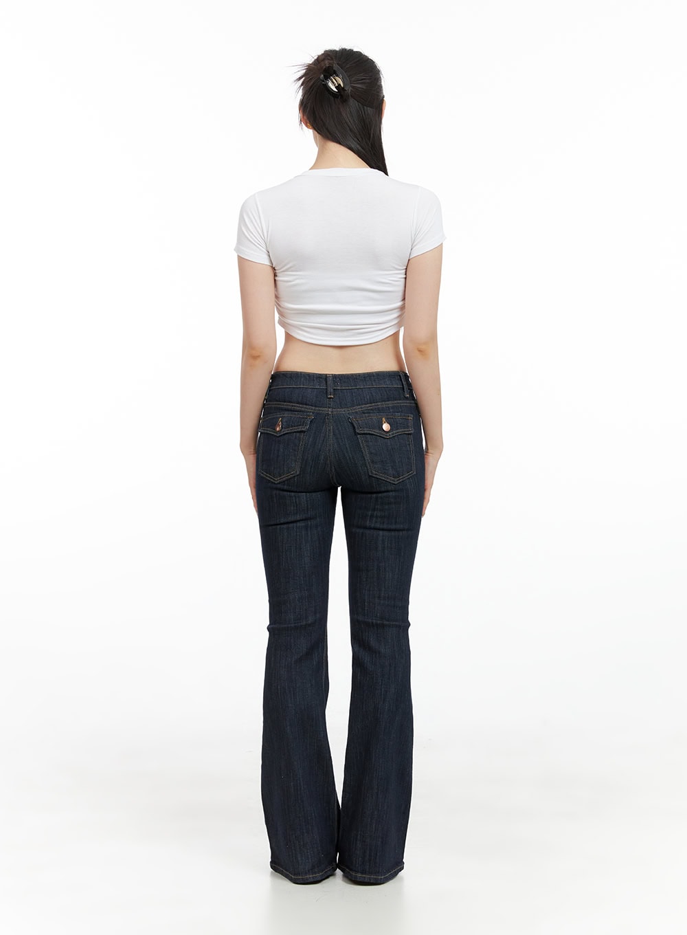 Lila Slim Fit Bootcut Jeans CG409 in dark blue, full back view on model, bootcut flare silhouette from behind, paired with white ruched crop tee, low-rise waist with belt loops.