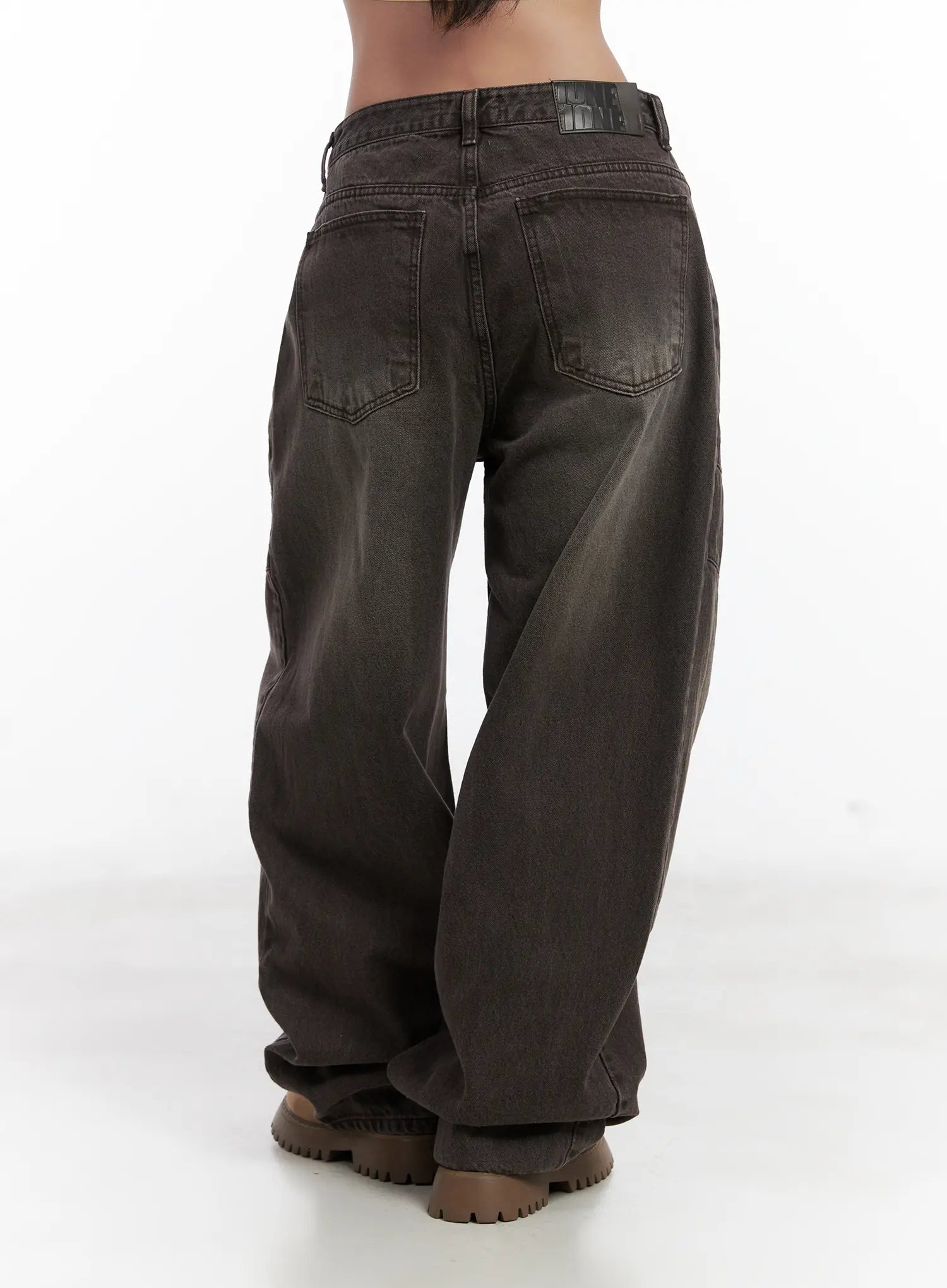 Elia Washed Baggy Jeans CN528 in dark brown, back close-up from waist to hem, showing dual back pockets, panel stitching, belt loop detail, and faded washed cotton texture.