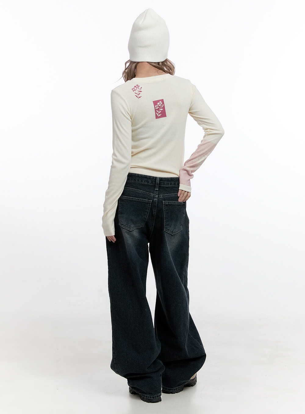 Camila Washed Cotton Jeans CN422 in dark blue, full-body back shot on model, oversize wide-leg washed denim paired with cream long sleeve and white beanie, back pocket detail visible.