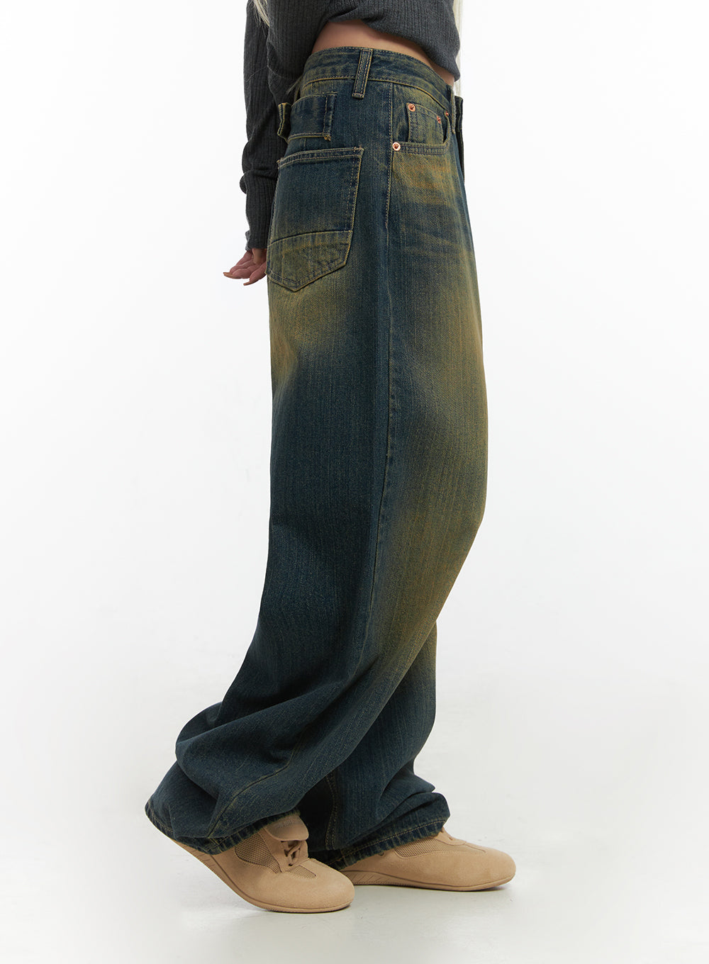 Georgia Vintage Wash Baggy Denim Jeans CO414 in dark blue, side close-up on model, oversized front patch pocket and heavy yellow vintage wash gradient visible, hem pooling over beige shoes.