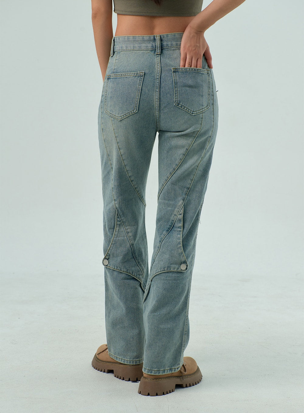 Straight Leg Jeans CY330 in light blue wash, back close-up from waist to hem on model, showing dual patch pockets, diagonal panel seams, and snap buttons at hem, straight fit.
