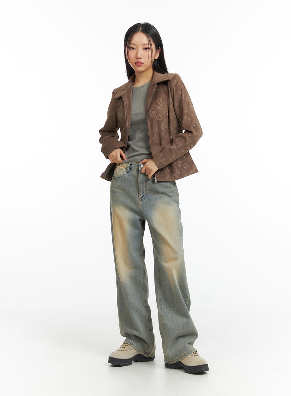Dark Wash Jeans CF303 in blue, full-body slight-angle shot on model adjusting jacket, wide-leg washed denim with sandy fade, paired with brown zip jacket and grey tee.