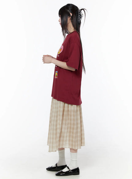 Plaid Flare Maxi Skirt CU519 in beige, side full-length styled shot on model in profile, paired with red graphic tee, showing flared tiered hem and skirt length, white socks and black Mary Janes.