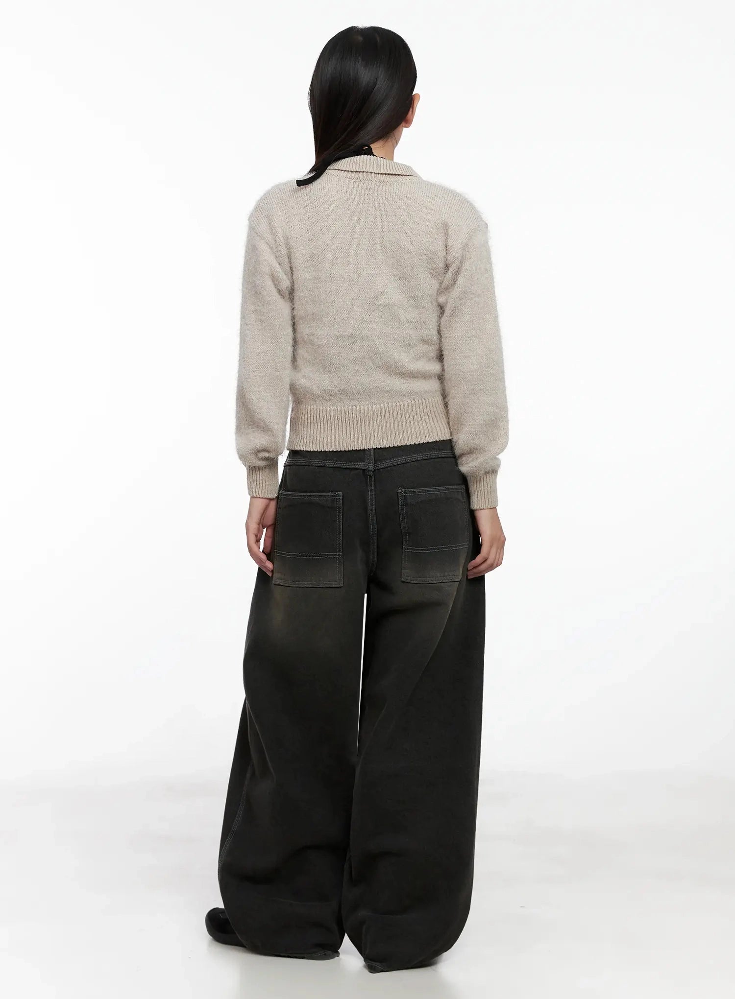 Hari Dark Washed Baggy Jeans IG527 in dark grey, full back view on model, oversized patch back pockets and contrast stitching visible, wide leg pooling at floor, styled with beige knit top.