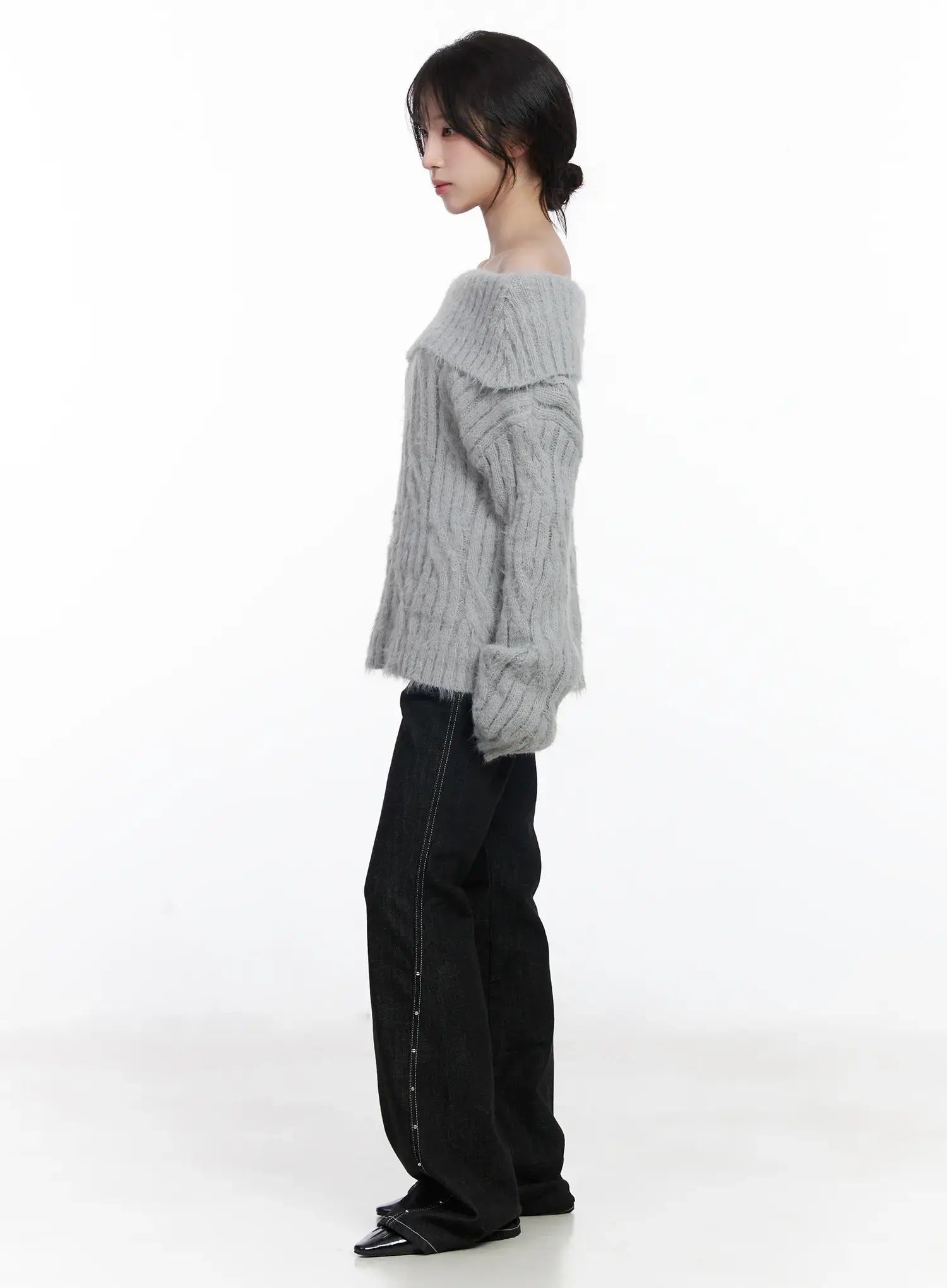 Dahy Stylish High-Waisted Bootcut Jeans CJ526 in black, side profile full-body shot on model with grey off-shoulder knit top, contrast stitch and stud side seam running full leg length.