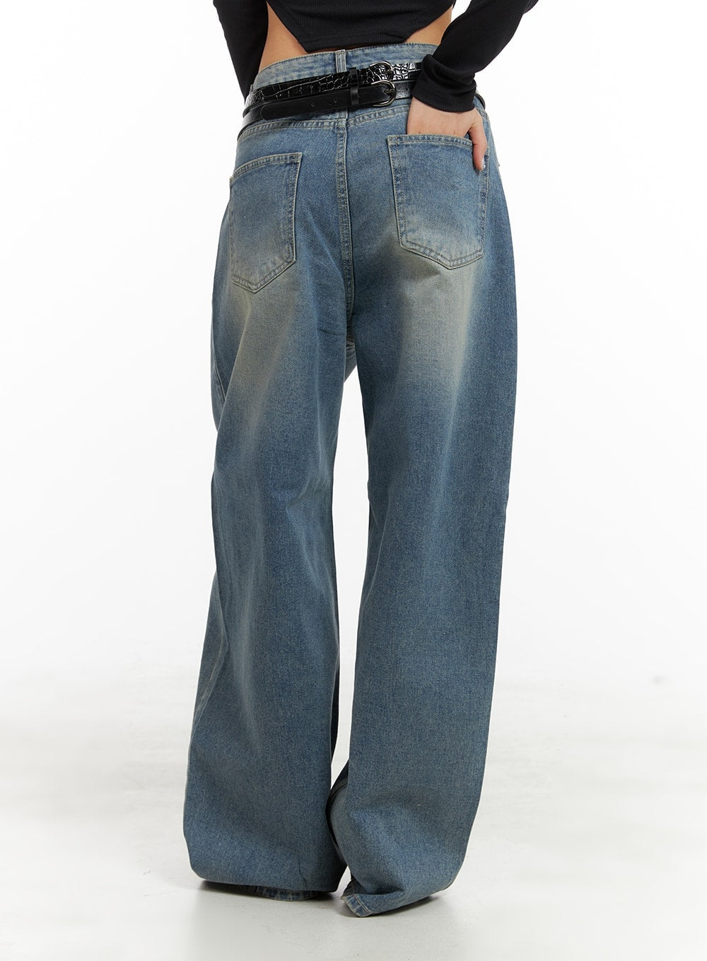 Washed Out Wide Fit Baggy Jeans CA416 in blue, back full-length view on model, rear patch pockets with washed fade, extra-wide leg pooling at hem, black belt.