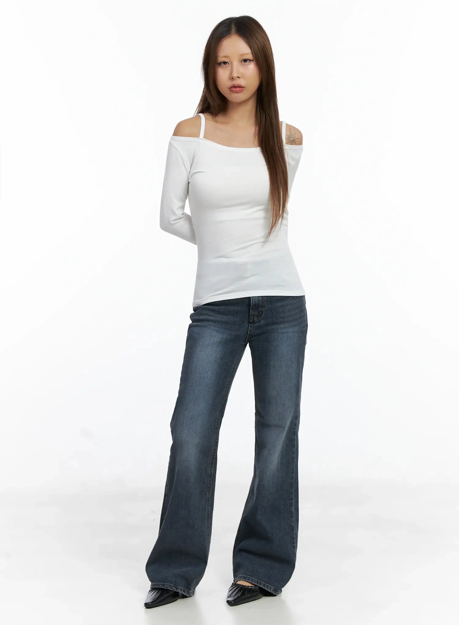 Rara Fleece Flared Jeans ID503 in blue, full-body front view on model, floor-length flared leg, styled with white cold-shoulder long sleeve top and black pointed mules.