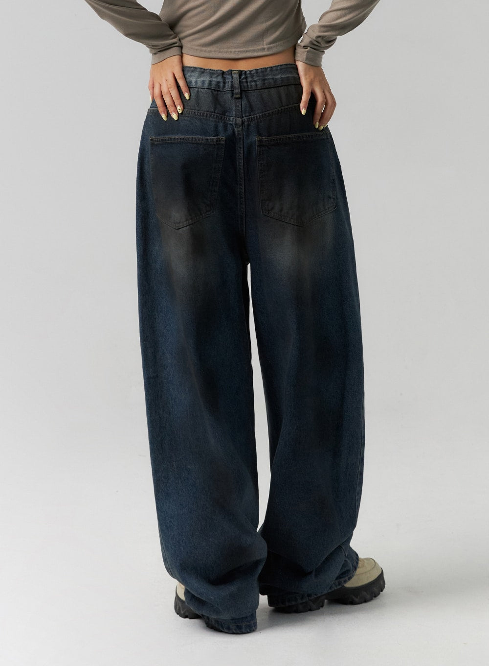 Tie-Dye Washed Wide Leg Jeans CS320 in dark blue, back close-up on model, showing patch back pockets, tie-dye washed denim and extra-wide leg silhouette with floor-grazing hem.