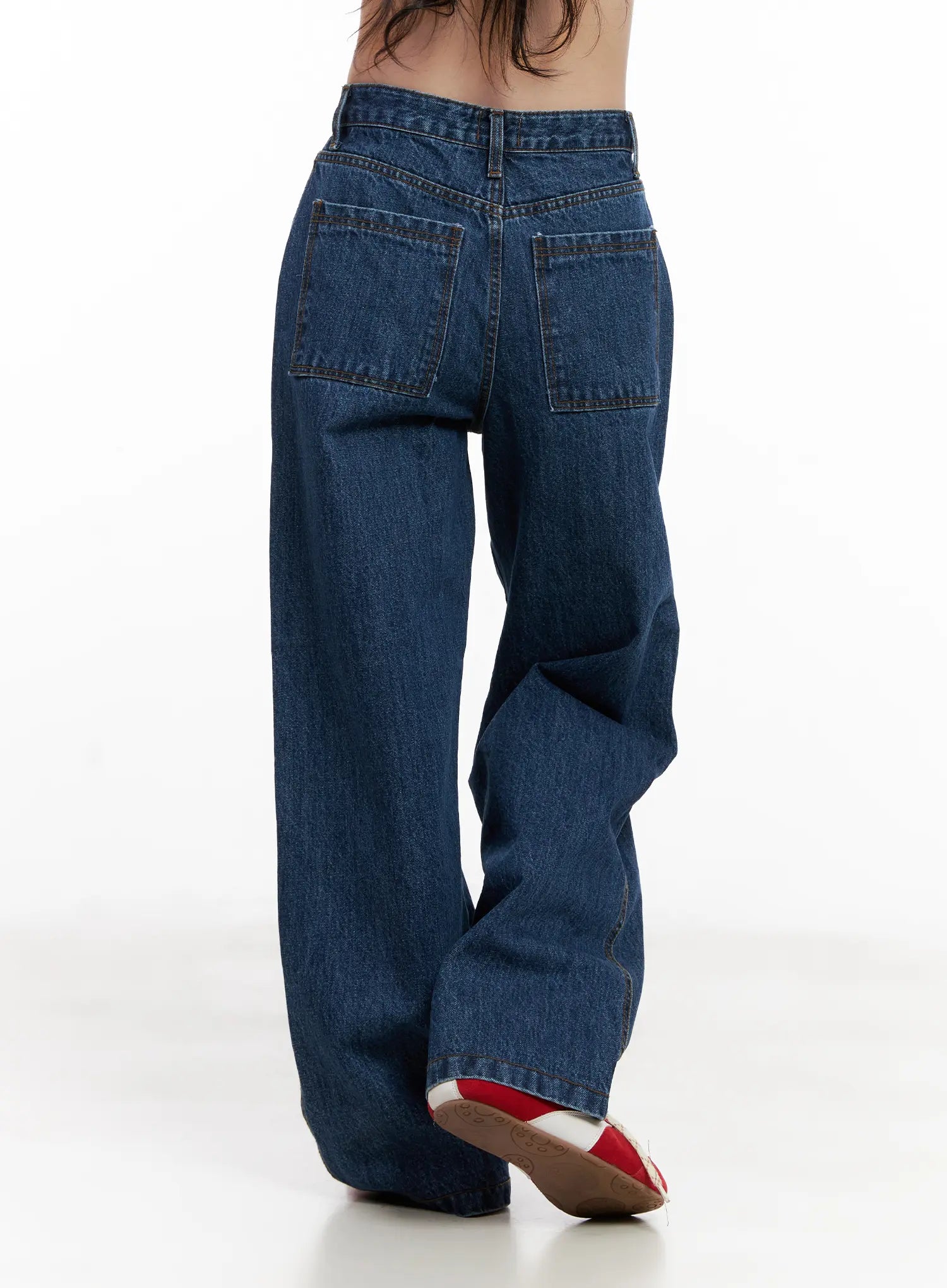 Ahyeon Classic Relaxed-Fit Denim Jeans CL515 in dark blue, rear three-quarter view on model, large patch pockets and wide-leg hem detail visible, cotton denim.
