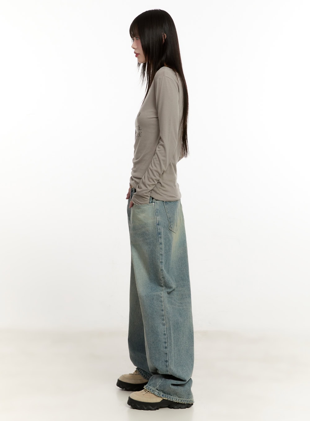 Galinda Washed Baggy Jeans CM513 in vintage blue, full-body side on model, paired with fitted beige long-sleeve top, extreme wide leg denim length grazing the floor, chunky shoes.