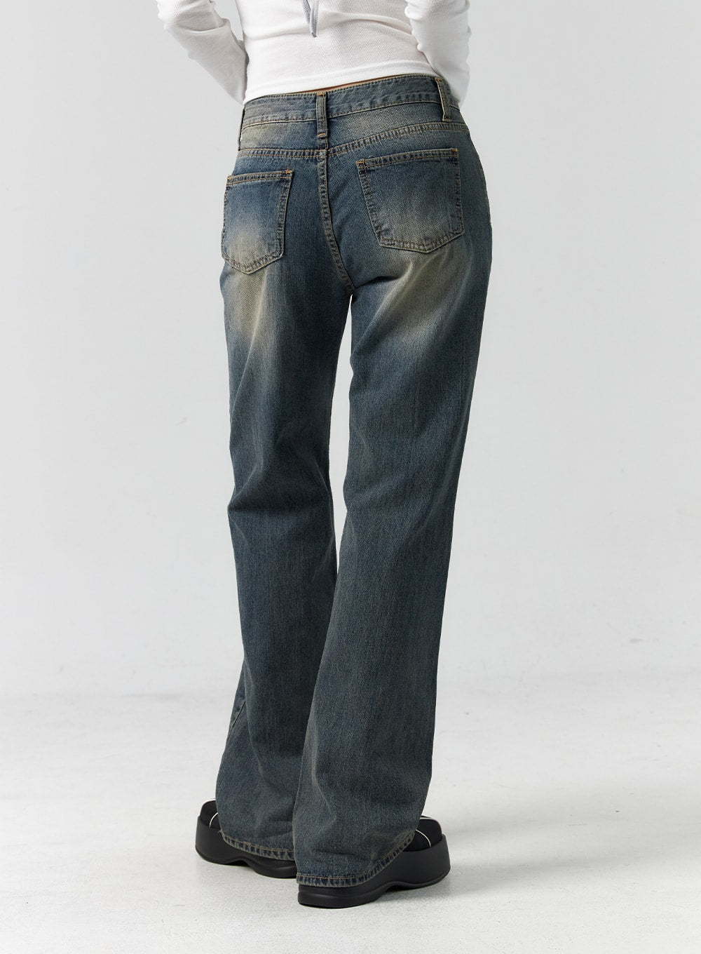 Vintage Wash Bootcut Jeans CS305 in blue, back view waist-to-hem on model, showing dual back pockets, vintage-washed fading, and bootcut hem flare.