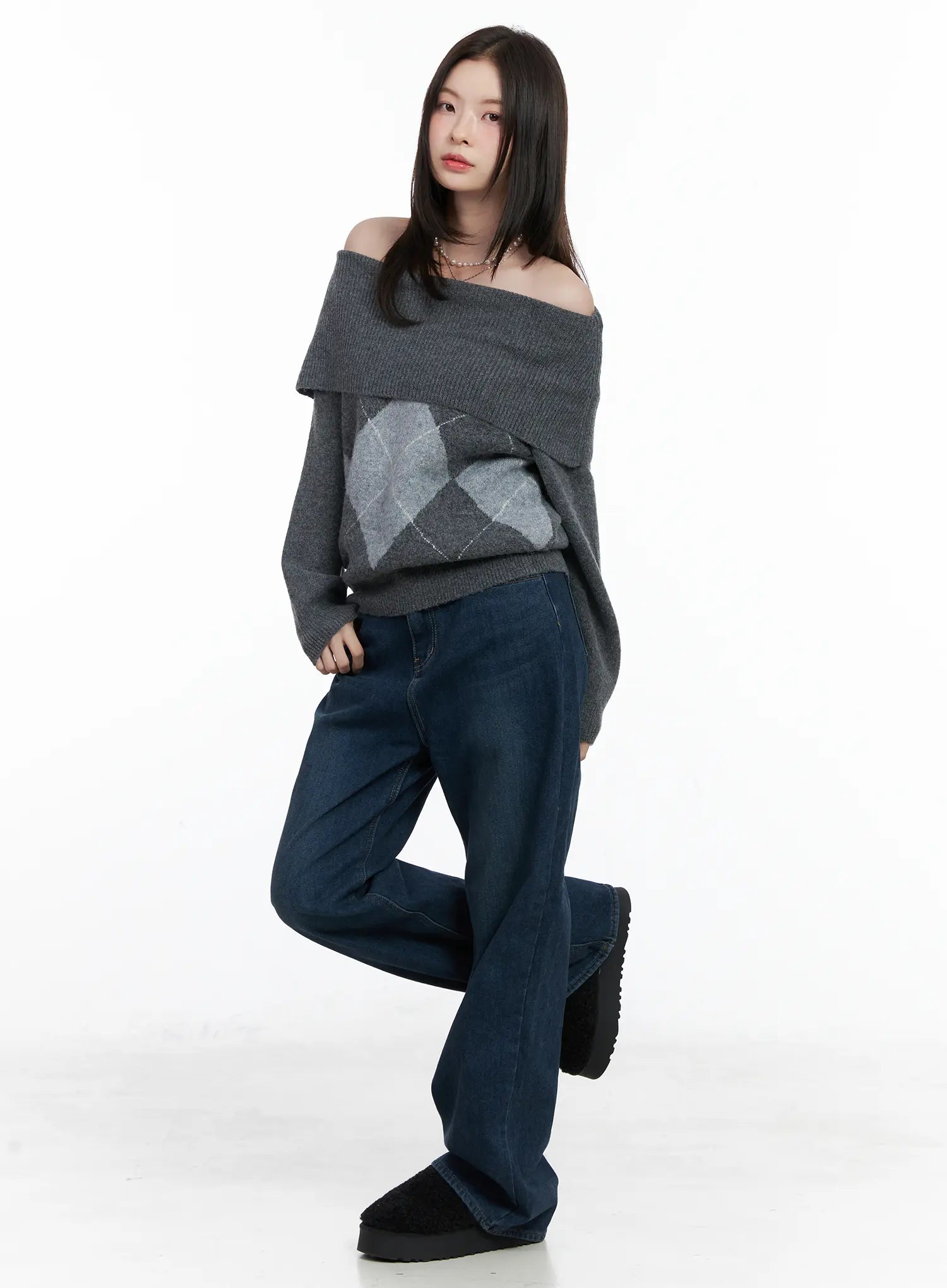 Jordan Velvet Fleece Wide Jeans CN518 in blue, full-body front view on model, one leg raised, paired with grey off-shoulder argyle sweater, wide-leg silhouette fully visible.