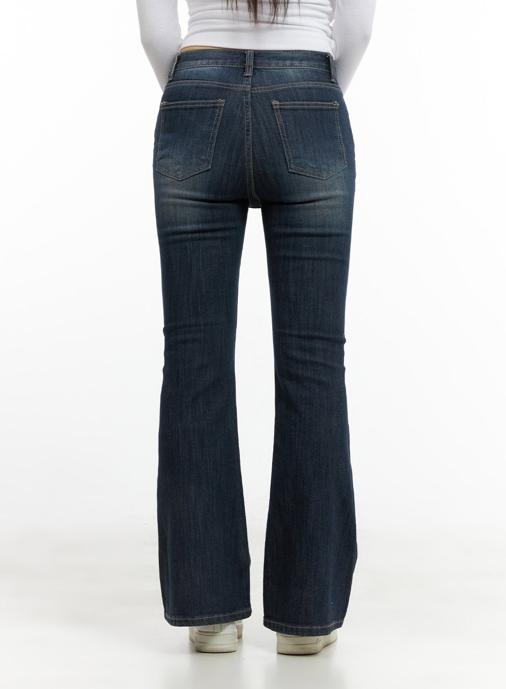 Remy Washed Bootcut Jeans CG420 in blue, back waist-to-hem close-up on model, dual back pockets with washed fading detail, slim bootcut silhouette, paired with white long sleeve top.