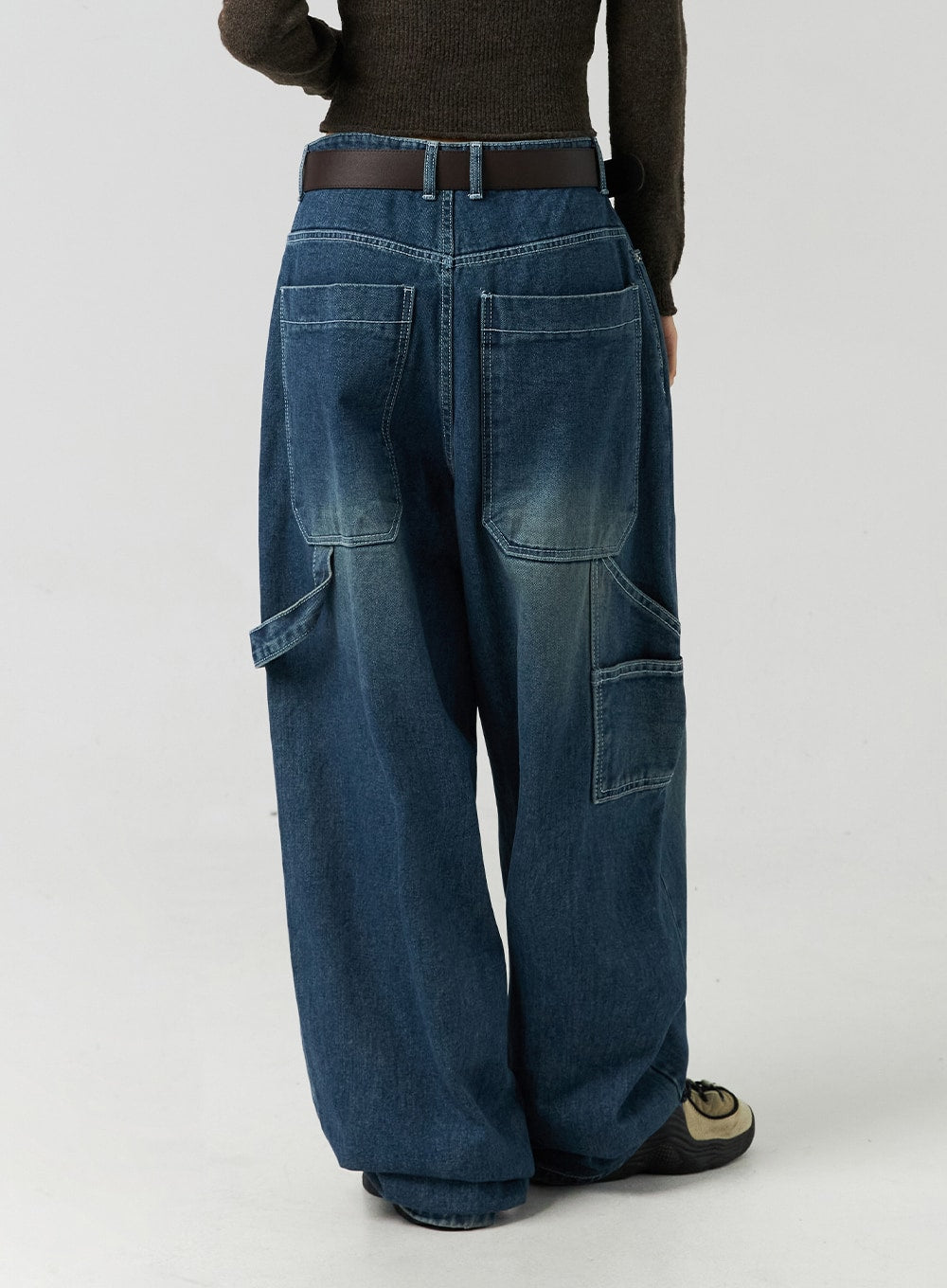 Washed Cotton Wide Leg Jeans CO323 in blue, back view close-up on model, large patch back pockets and cargo-style side pockets visible, washed cotton denim with contrast stitching.
