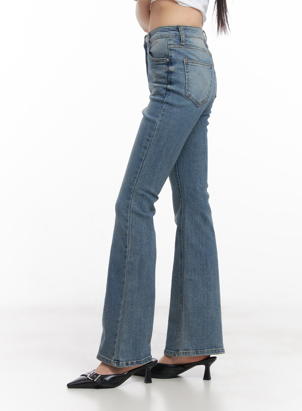 Cassy Slim Washed Flared Jeans CY512 in blue, close-up side view from waist to hem on model, highlighting slim fit through thigh and bootcut flare, with black kitten-heel mules.