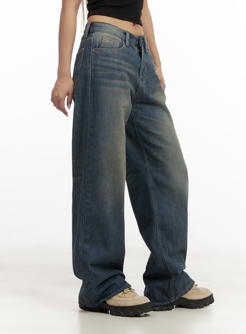Michelle Washed Wide-Leg Jeans CJ508 in blue, side waist-down shot on model, low-rise washed denim showing wide leg silhouette and five-pocket construction, with chunky sneakers.