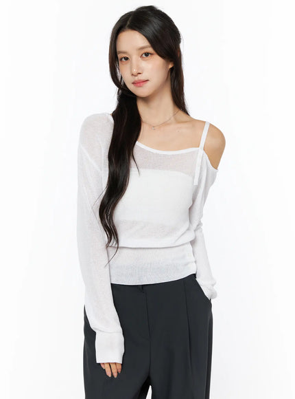 One-Shoulder Knit Top CU522 in white, front three-quarter view on second model, sheer lightweight knit with one cold-shoulder cutout and spaghetti strap, ribbed cuff detail visible.