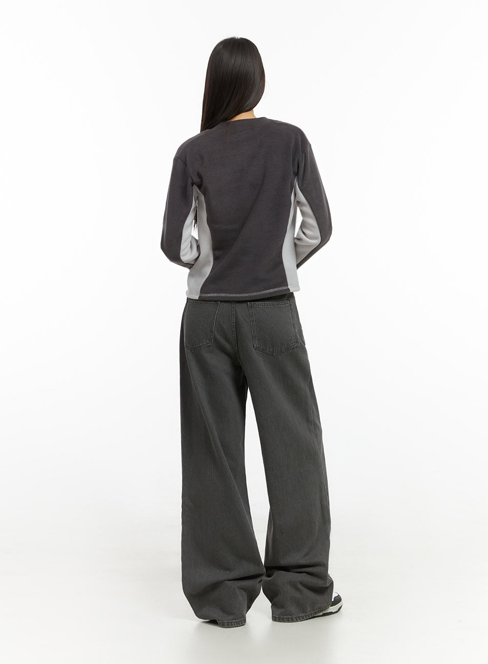 Emery Cotton Strap Baggy Jeans IO409 in dark gray, back full-length view on model, showing patch back pockets and wide-leg silhouette, paired with colorblock sweatshirt.