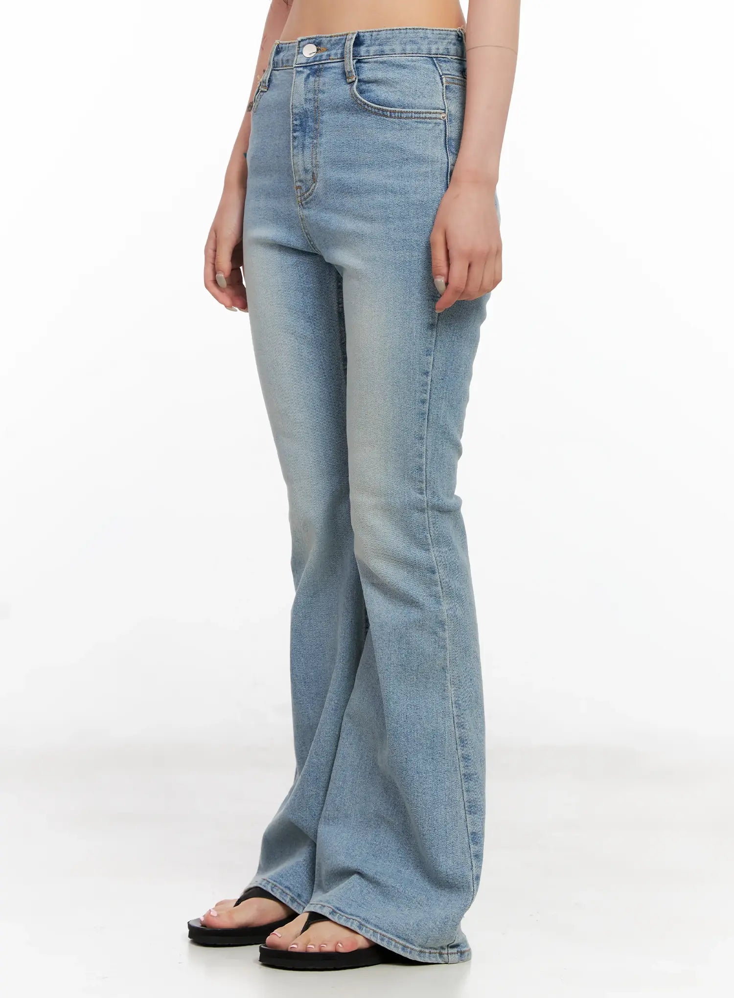 Byeol Washed Flare Denim Jeans CL525 in light blue, side view on model, slim-fit high-rise flare with washed cotton fabric and long inseam, worn with black sandals.