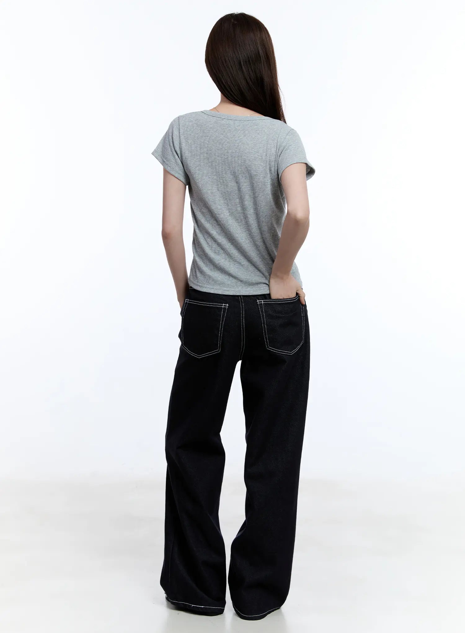 Nayeon No-Fade Denim Jeans CU513 in dark blue, full back view on model, showing dual patch pockets with white contrast stitching and wide-leg hem, styled with grey tee.
