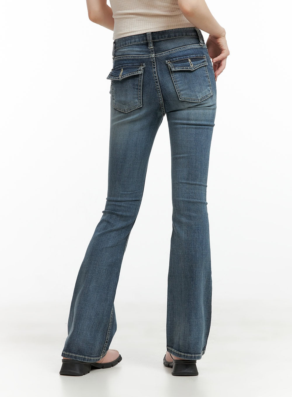 Tight Fit Low Waist Bootcut Jeans CL403 in dark blue, back three-quarter close-up on model, dual flap back pockets with arrow stitching detail, washed denim bootcut flare.