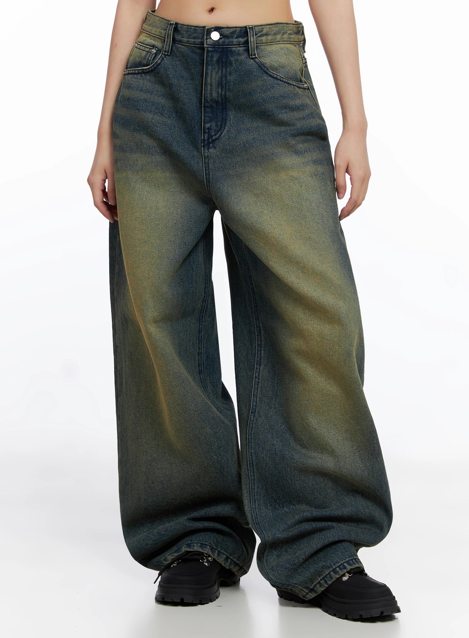 Elora Washed Baggy Jeans IS525 in dark blue, front mid-shot on model, ultra-wide-fit washed denim with yellow-green fading, pooled hem over black chunky shoes.