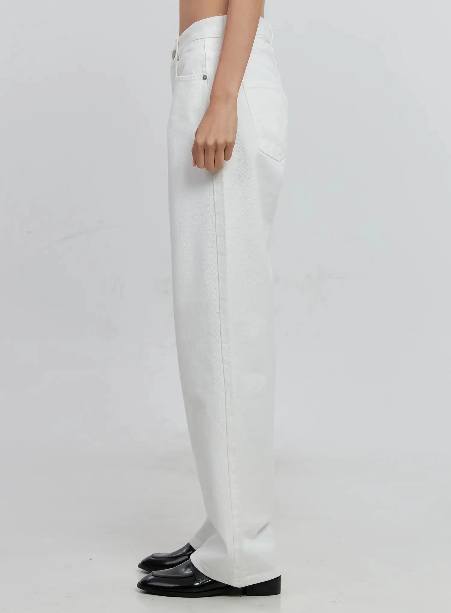 Taytum Straight-Leg Jeans IS515 in white, side view on model, straight-leg long cotton denim showing slim side profile, back pocket rivet, and floor-length inseam.