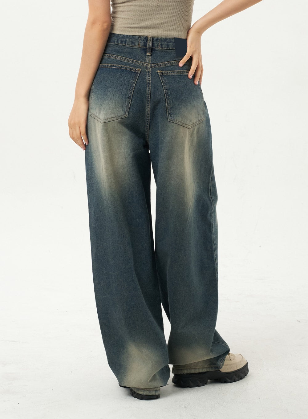 Mid-Rise Baggy Jeans CA325 in vintage blue denim, back three-quarter view on model, showing dual back pockets with contrast stitching and sun-faded wash across wide-leg silhouette.